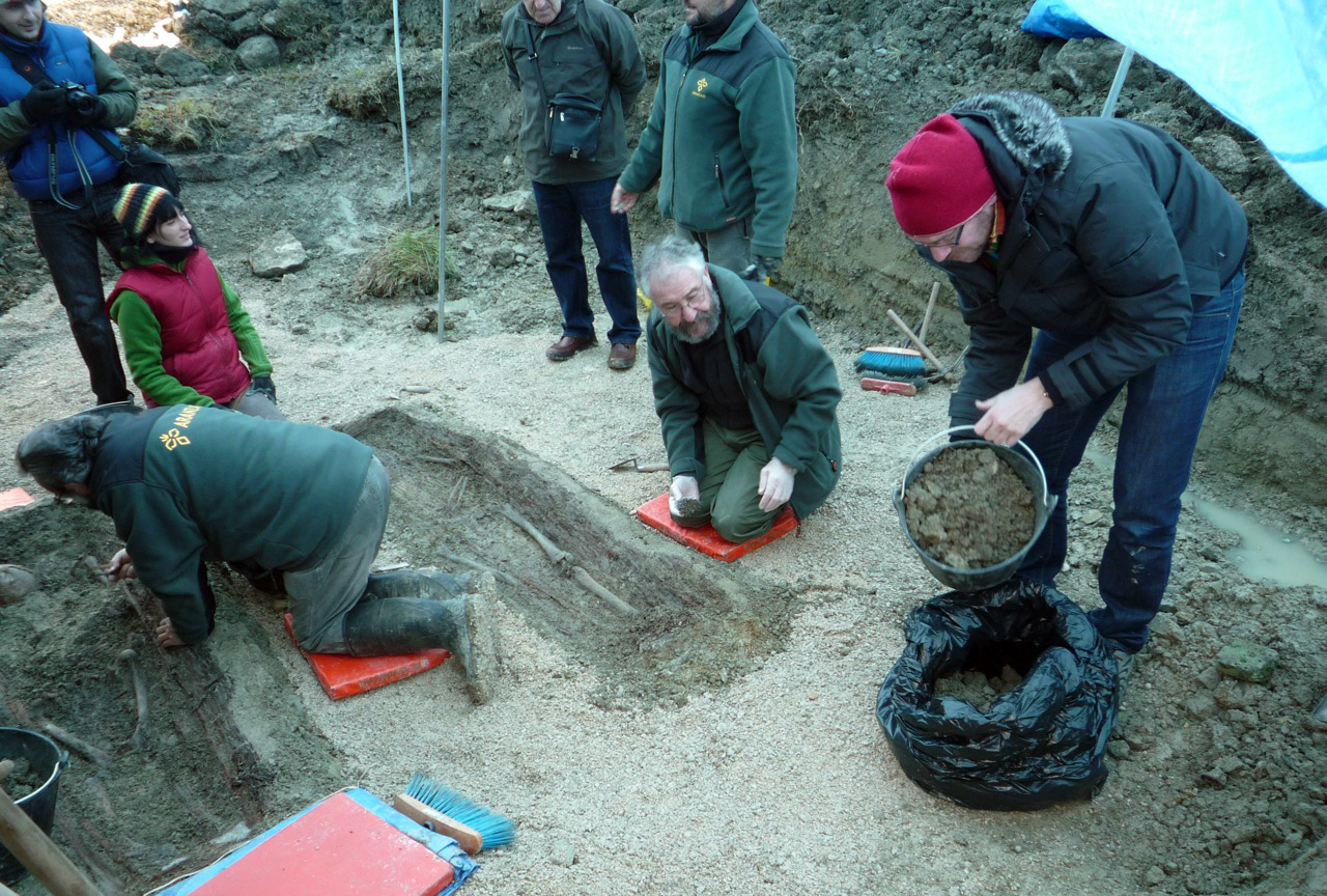 Collecting soil from the mass grave